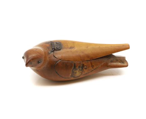 A carved bird snuff box, 19th century, modelled as a bird, the wing as the hinged cover, inset eyes and coloured details, 11c