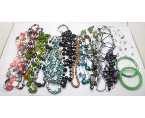 A collection of glass bead jewellery and two jade bangles 