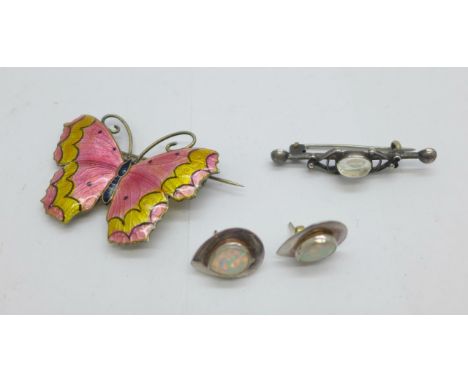 An enamelled silver butterfly brooch, a pair of silver and synthetic opal earrings and a silver brooch 