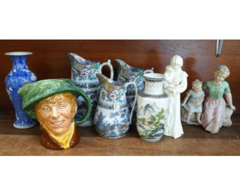 A set of three graduated ironstone chinoiserie jugs, two Chinese vases, a Royal Worcester figure Once Upon a Time, a Royal Do
