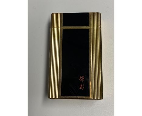 A Dupont gold plated and black enamel lighter with red Chinese calligraphy 