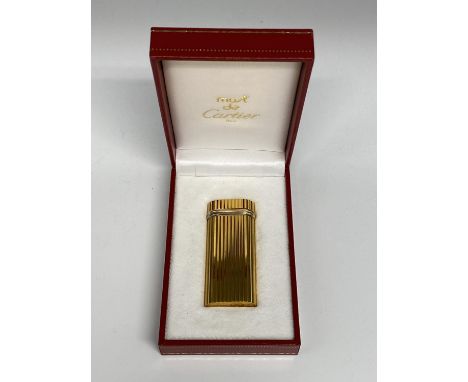 A Cartier Gold plated lighter in red tooled Cartier Box 