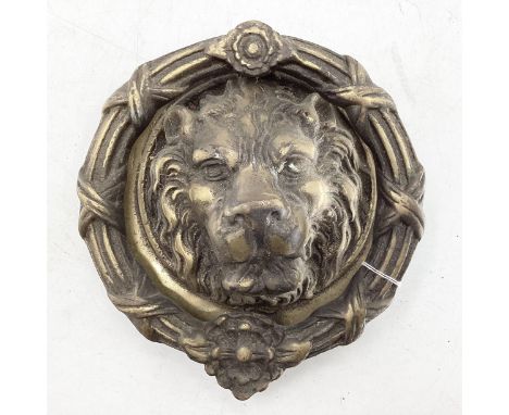 Large brass door knocker in the form of a lions head 