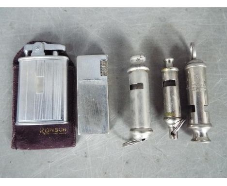 Three vintage whistles to include an ARP and an ACME Guide and two vintage cigarette lighters.