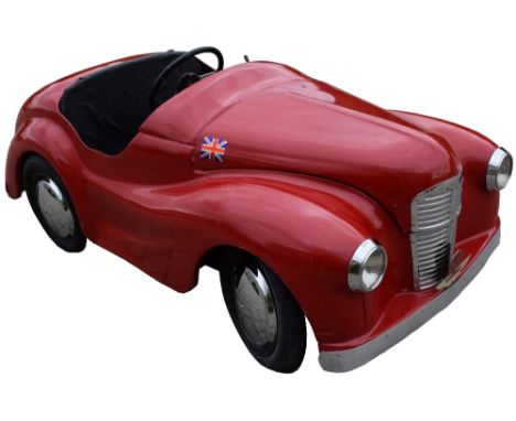 A Classic Austin J40 Pedal Car in red, has been restored overtime, pressed steel bodywork repainted, bumpers replaced, presse