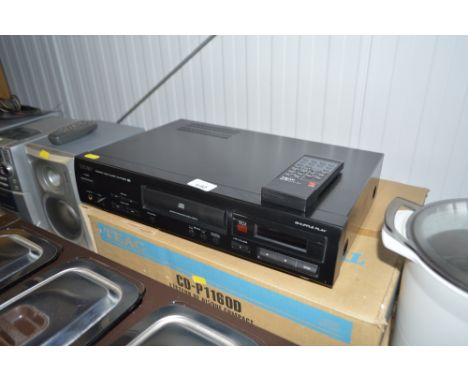 A Teac compact disc player with remote control and original box