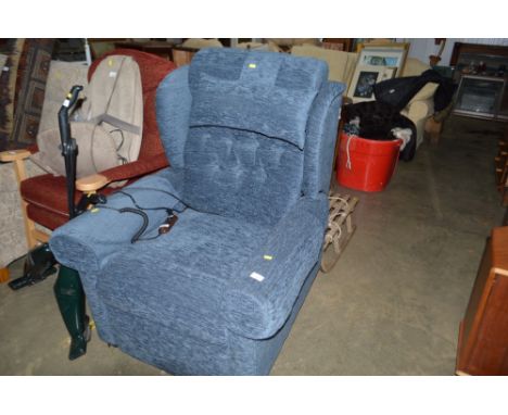 A blue upholstered button back rise and recline armchair 