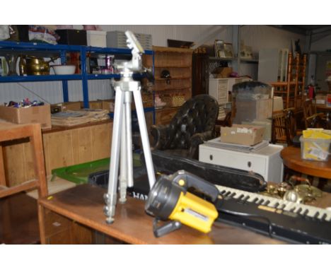 A camera tripod; torch