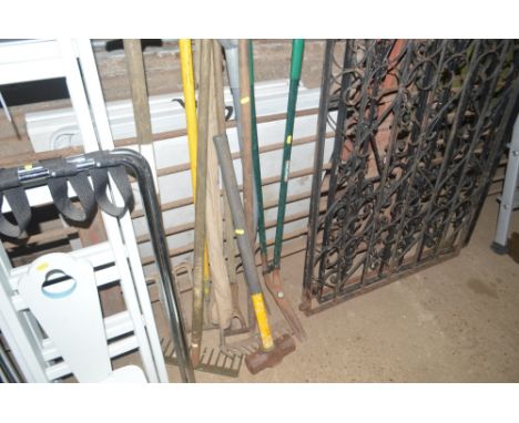 A quantity of long handled gardening tools; and a fishing rod