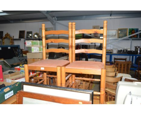 A pine drop leaf table with a set of four ladder backed chairs