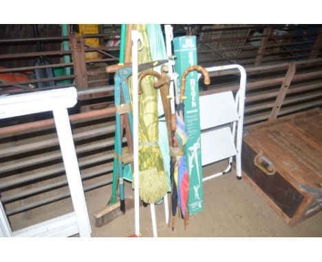 A quantity of long handled gardening tools; parasols; walking sticks etc