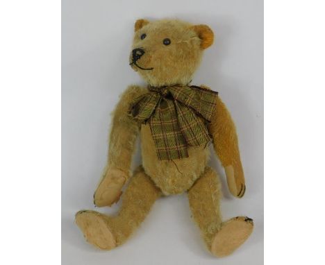 An early 20thC brown mohair hump back Teddy bear, with an elongated snout, possibly Steiff, 38cm high.