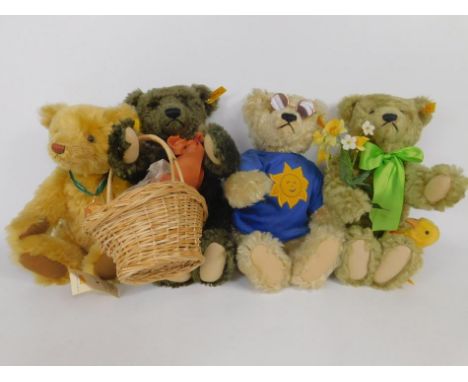 Four Steiff teddy bears, to include one with jumper and glasses, one with bow and basket of fruit, another with flowers and c