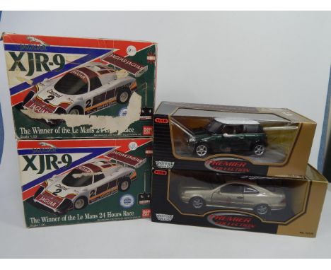 Two boxed BanDi XJR-9 die-cast remote control cars, and two premier collection 1:18 scale boxed diecast metal cars (4).