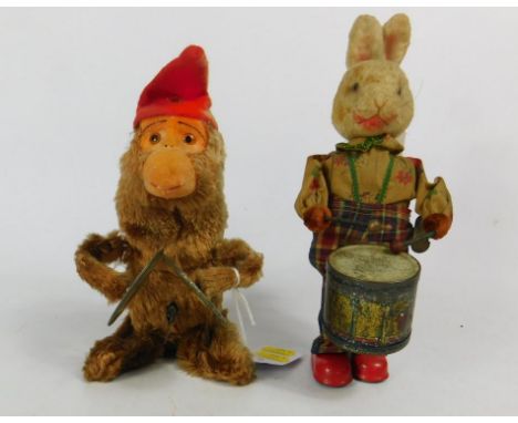 Two clockwork musicians, a monkey playing cymbals and a rabbit playing a drum.