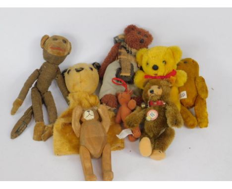 A Norah Wellings monkey rag doll, Steiff Teddy bear, 15cm high, Sooty hand puppet, wooden carved jointed bear and four furthe