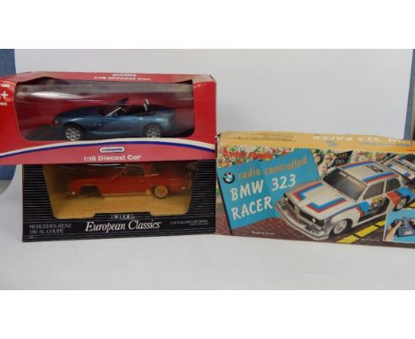 Various die cast vehicles, comprising a 1:18 KiD collection cabriole, 21cm wide, a BMW 323 Radio Shack racer, and a Ertl Euro