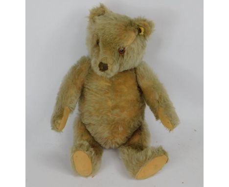 A Steiff Teddy bear, late 20thC, with inoperative growler, moveable head, button and label to ear, 40cm high.