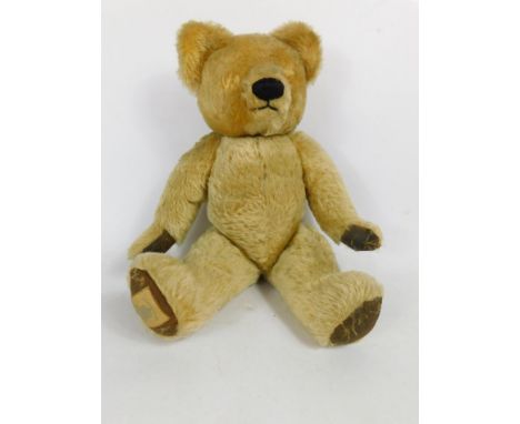 A Chad Valley teddy bear, lacking eyes, (AF), 49cm long.