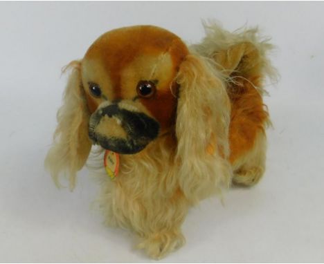 A Steiff model dog, with original label, named Peky, 18cm long.