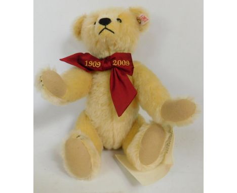 A modern Steiff Margaretes Teddy Bear, with 1909-2009 red bow, white label and brass button to ear, and growling mechanism, 2