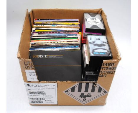 A small quantity of various 7" vinyl records and cassette tapes, including 808 State, Massive Attack, Enigma, KLF, The Prodig