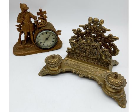 An antique French spelter mantle clock, and a brass desk stand.