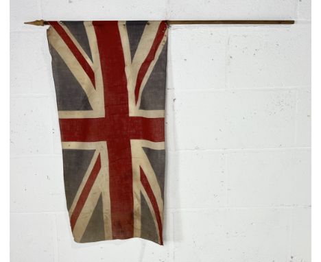A small vintage union flag on wooden pole 