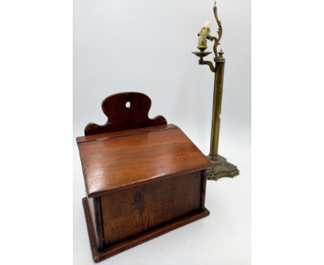 An antique mahogany candle box and a brass candlestick.