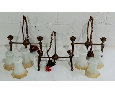 A set of three vintage brass pendant light fittings with glass shades, one A/F.