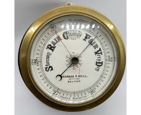 A brass and mahogany mounted aneroid barometer by Sharman D Neill, optician Belfast.