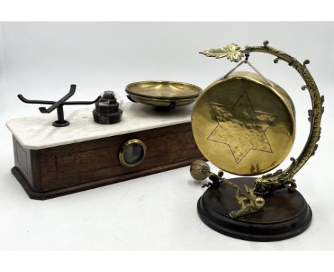 A brass table gong with stylised dolphin frame along with a vintage set of scales