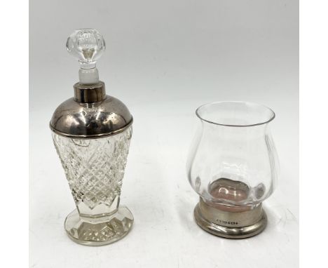 A silver topped cut glass scent bottle along with a Dartington Crystal "Hurricane Janie" candleholder with silver base