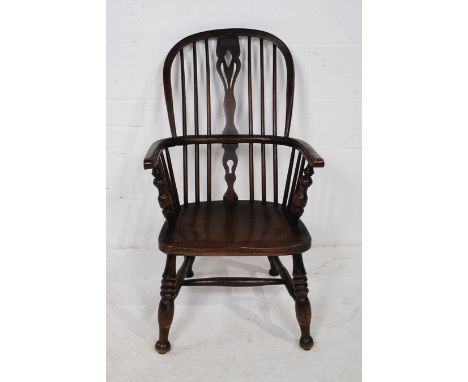 An antique elm Windsor stick-back chair, with turned detailing