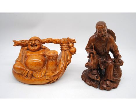 Two Oriental wooden carvings, of a laughing Buddha and a man smoking an opium pipe - some damage 