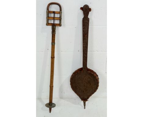 A vintage bamboo shooting stick and a pair of carved oak bellows.