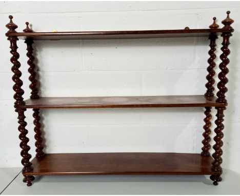 An antique mahogany three-tier wall shelf with barley twist supports, 75cm wide, 60cm high.