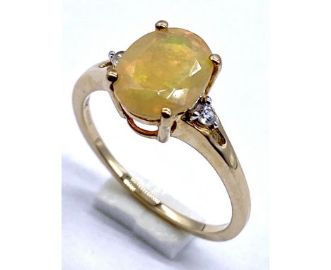 A 10K/375 gold Ethiopian opal set with single diamond to each shoulder, Size N1/2 - 2.1g total.