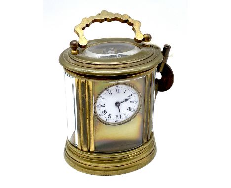 A miniature brass carriage clock of oval form, the movement with H J parrot mark for Henri Jacot, numbered 5807 to underside