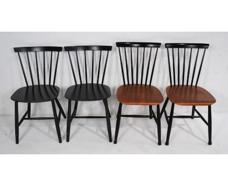 A pair of retro black painted 'Mobler' stick-back chairs, along with another pair similar 