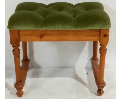 A pine dressing table stool with green velvet, button back upholstery.