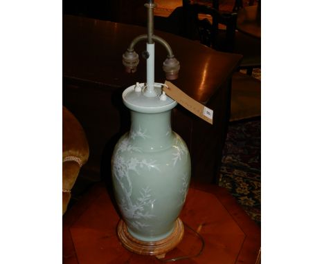 A pair of Japanese porcelain celadon lamp bases, decorated with foliage and birds. H.62cm