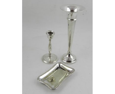 A silver trumpet vase, together with a small silver candlestick, and a silver dish. (3)