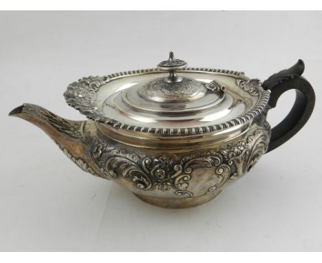 An early 20th century silver teapot, together with matching silver sucrier and jug, repoussé embossed, hallmarked London 1913