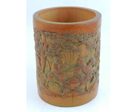 A Chinese carved bamboo brush pot, decorated with a hunting scene. 