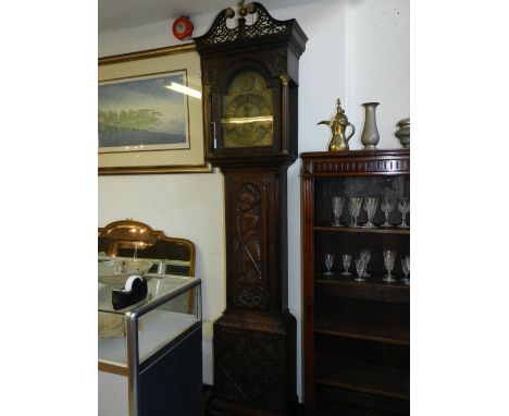 A 19th century oak longcase clock, the case with broken swan neck pediment above a broken arch glazed door flanked by fluted 