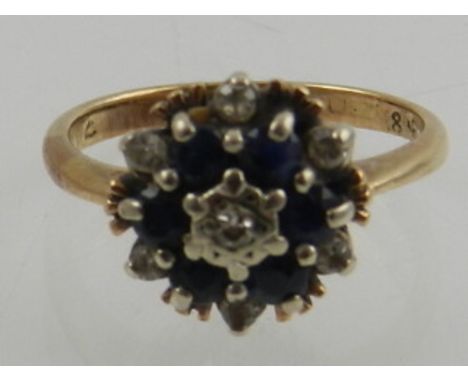 A 9 carat yellow gold, diamond, and sapphire cluster ring. 