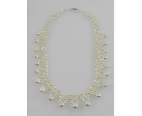A button and cultured pearl bib necklace, with a 14 carat white gold clasp. 