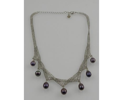 A silver mesh and black pearl drop necklace. 