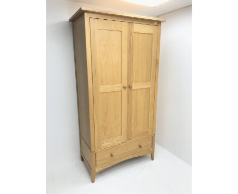Solid ash double wardrobe, two drawers enclosing hanging rail and shelf above single drawer, tapering stile supports, W108cm,